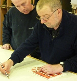 The artist working out his designs. Photograph from the Norwich Cathedral website.