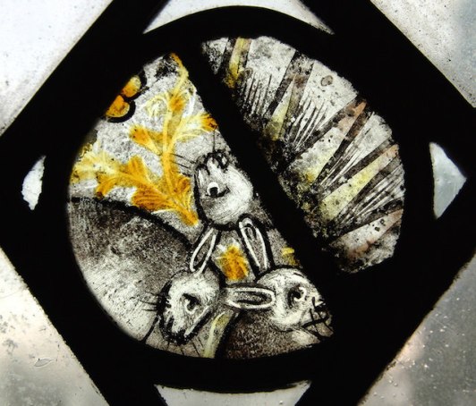 The 'Three Hares' roundel. Three ears are visible yet each hare has two ears! Painted glass, Holy Trinity, Long Melford.